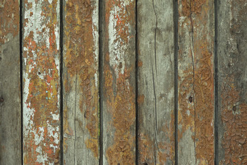 The old wooden fence with paint leftovers