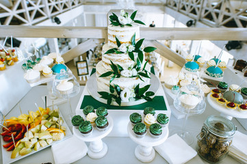 White wedding cake decorated with cream and fruits