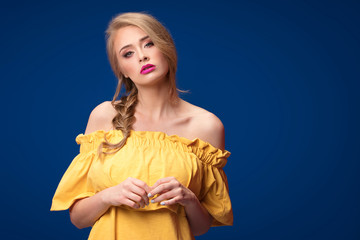 Beautiful blonde girl with braid and glamour makeup.