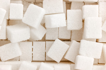 Cubes of sugar on a white background. Many cubes of sugar close-up.