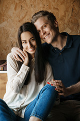 A loving young couple hugging sitting and holding each others hands. A loving mood.