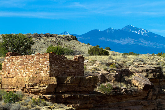 The Box Canyon ruin inside Wupatki National Monument in northern Arizona protects an ancient Native American pueblo site. This image shows the San Francisco Peaks in the background