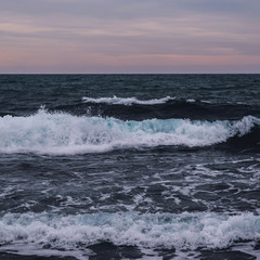 Storm at sea, red-blue sunset at dusk