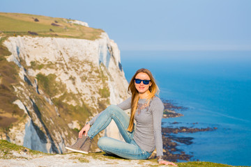 Girl hiking at the edge of the white cliff of Dover in United Kingdom