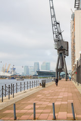 Huge black crane monument standing by the river bank at the docks in London near Excel