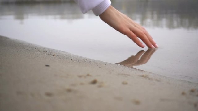 Girl Puting Hand in Water in Slow Motion