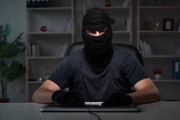 Hacker hacking computer late at night