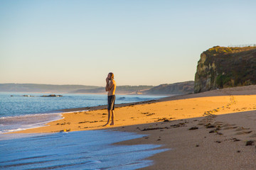 Beautiful ocean view from above on surfers going for the beach. Early morning ocean view in...