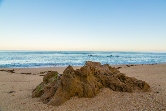 Beautiful ocean view from above on surfers going for the beach. Early morning ocean view in Portugal.