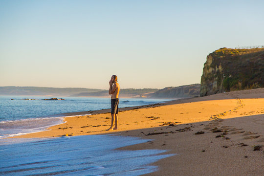 Beautiful ocean view from above on surfers going for the beach. Early morning ocean view in Portugal. - Powered by Adobe
