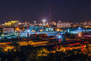 Fototapeta na wymiar Night Voronezh cityscape, aerial view to industrial area and television broadcast tower