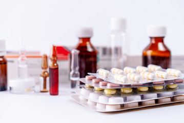 Ampoules, pills, packs with medicine remedy, vitamins on a white background