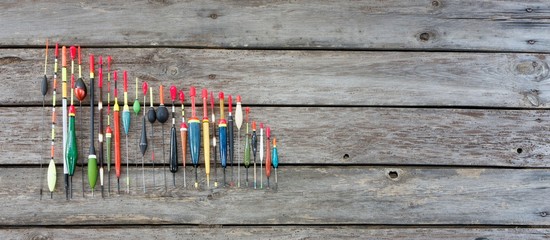 Fishing floats in different shapes on wooden background © mtmmarek