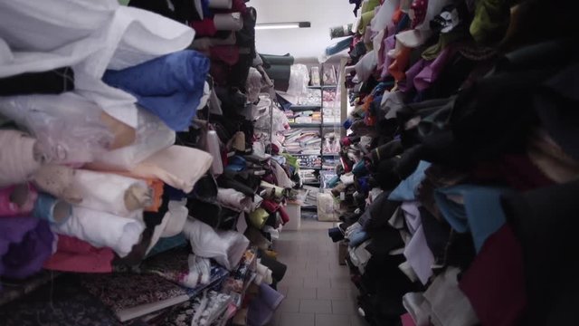 Tracking shot, shelves of textiles