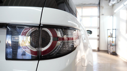 Fototapeta premium Car on a car wash, close-up headlight