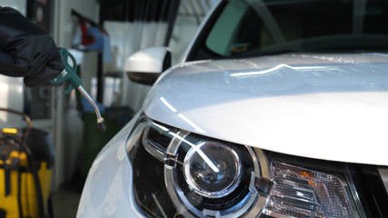 Car on a car wash, close-up headlight