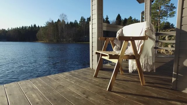 chair on the terrace of the house on the lake on a sunny day