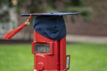 Graduation cap on a red pipe