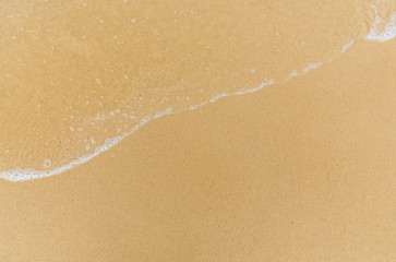 Ocean sea waves on the beach in a resort city with a copy space. Concept of summer, holidays, vacation, travel, and beach