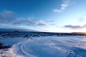 Naklejka premium Sunset on icelandeic tundra with snow and ice