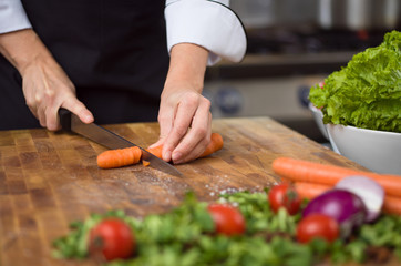chef hands cutting carrots