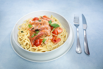 Linguine with shrimps and cherry tomatoes. The shrimps of the Mediterranean are precious crustaceans, the sauce is also accompanied by pepper and fresh parsley