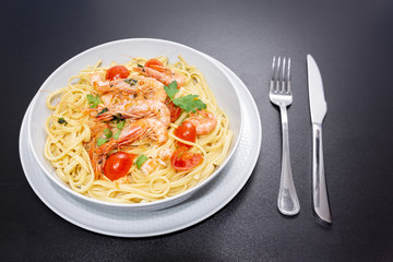 Linguine with shrimps and cherry tomatoes. The shrimps of the Mediterranean are precious crustaceans, the sauce is also accompanied by pepper and fresh parsley