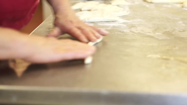 Rolling dough on counter, close up