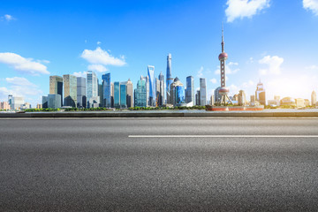 Fototapeta na wymiar urban asphalt road and modern commercial buildings in shanghai