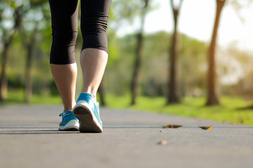 young fitness woman legs walking in the park outdoor, female runner running on the road outside,...