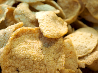 Macro close up pile of Thai local traditional street food snack, deep fried crisp shrimp rice cracker (Kao Krieb Koong or Krupuk) 