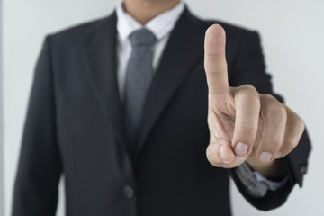 Business man is pointing to the screen.