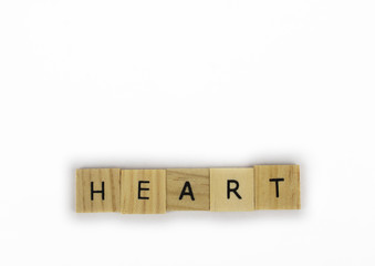 Wooden tiles spelling out the word heart on an isolated white background. Inspirational and motivational!  Room for text! 