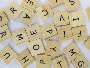 Tiles with letter in a pile on an isolated white background