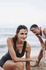 Fototapeta premium Couple stretching at the beach