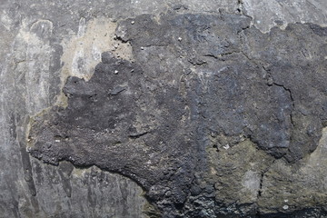 Old felt roofing tar fragment as an abstract background