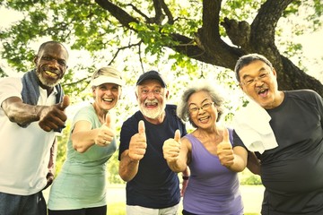 Active senior friends exercising at the park