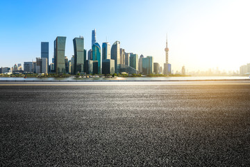 empty asphalt road and city skyline in shanghai at sunset