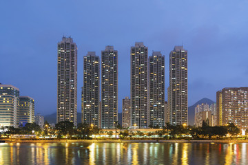 Fototapeta na wymiar High rise residential building and river in Hong Kong city at dusk