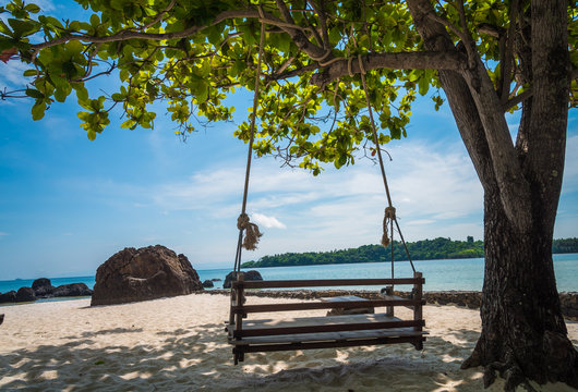 The wooden swing hanging under tree on beach koh kham island ,trad,Thailand