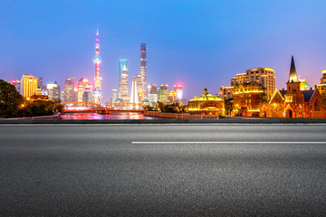 Fototapeta na wymiar clean asphalt road with city skyline background,shanghai,china