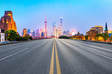 Fototapeta na wymiar clean asphalt road with city skyline background,shanghai,china