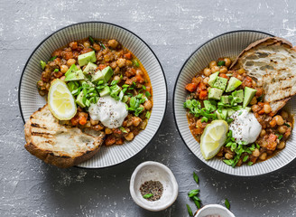 Served lunch vegetarian buffalo chickpea chili with mushrooms  on a gray background, top view. Healthy vegetarian food concept