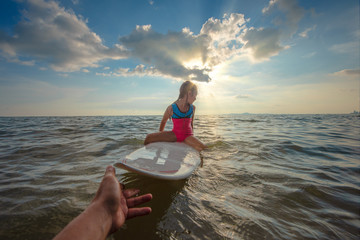 girl is obstinacy and conviction in refused or decline a hand help to support playing surfboard in sea water - obrazy, fototapety, plakaty