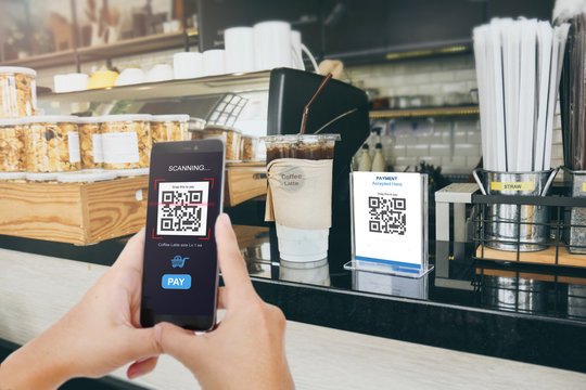 Qr code payment, E wallet , cashless technology concept. Man scaning  tag in Coffee accepted generate digital pay without money.