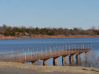 Wooden lookout with railings over a bridge Thunderbird Lake State park in Oklahoma on a cold day 