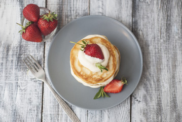 Sweet Pancakes with Cream and Strawbery. Health Breakfast Fruit Berry Vitamine Gray Rustic Wooden Background