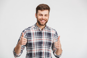 Portrait of a smiling young man showing thumbs up