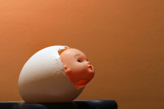 Hollow shell from the egg with the head of the doll inside.Close-up