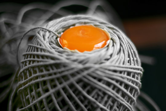 raw egg yolk in the middle of a skein of yarn